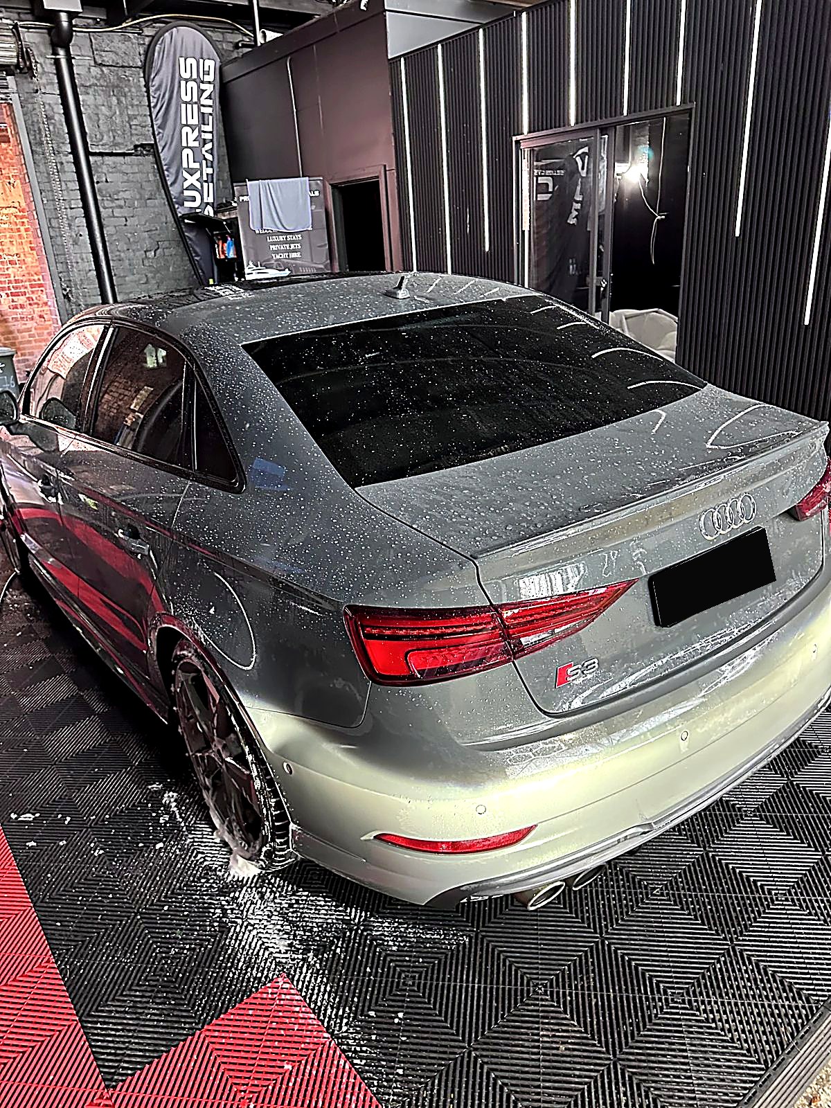 Before — dust and water-spotted Audi S3 in the studio