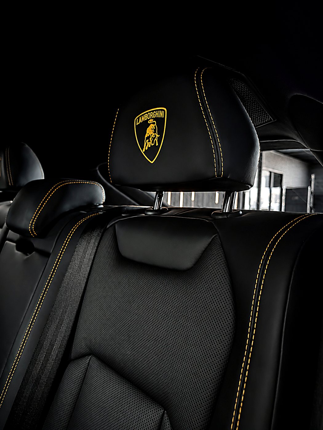 Lamborghini interior — embroidered headrest and yellow-stitched black leather