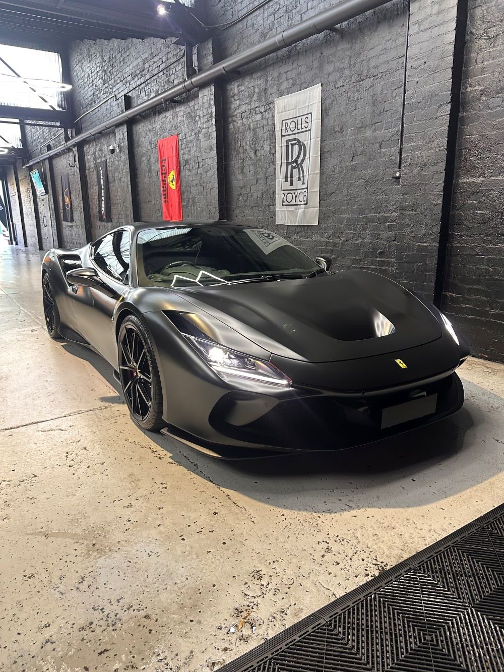 Paint protection film application in progress on a dark vehicle