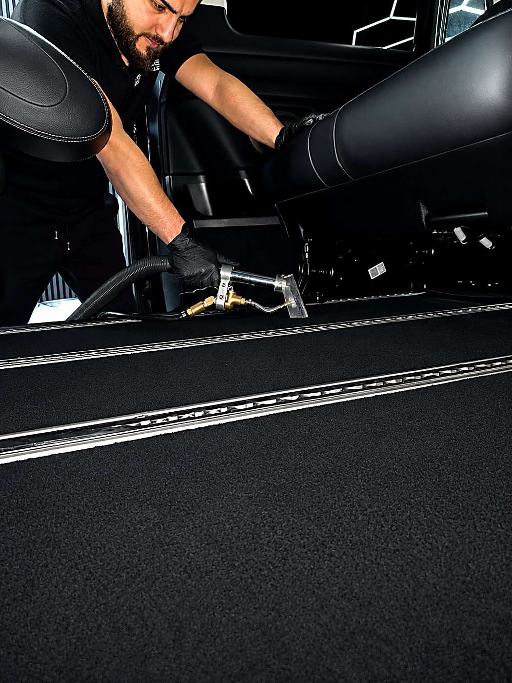 Luxpress detailer steam-cleaning a leather interior